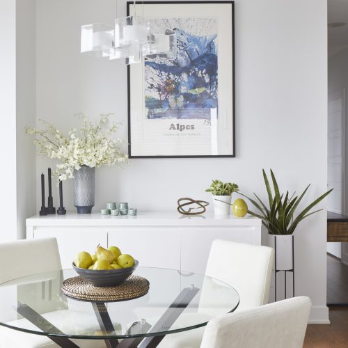 toronto condo renovation - modern scandi dining room with glass table - decorating with white - modern chandelier light fixture - wood floors - linda mazur design toronto designer - small space living