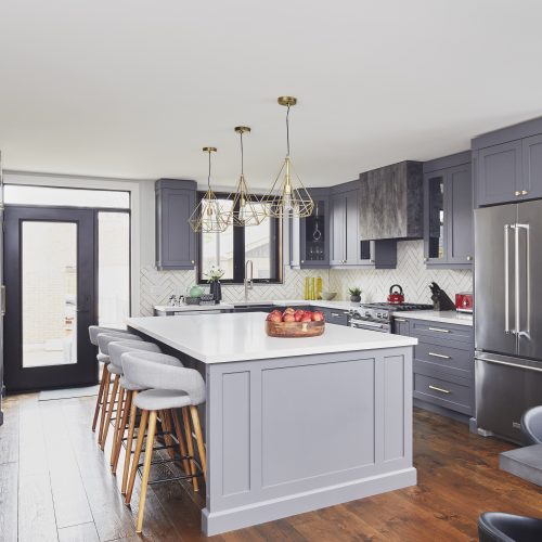 annex area toronto home renovation - small space open concept living - black windows dark grey kitchen cabinetry white quartz counters - gold lighting and scandi barstools - white chevron tile backsplash - linda mazur design toronto designer