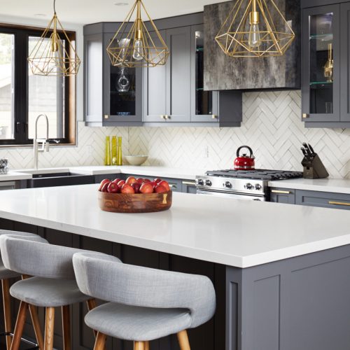 toronto life - toronto home renovation - small space open concept living - dark grey kitchen cabinetry white quartz counters - gold lighting and scandi barstools - white chevron tile backsplash - linda mazur design toronto designer