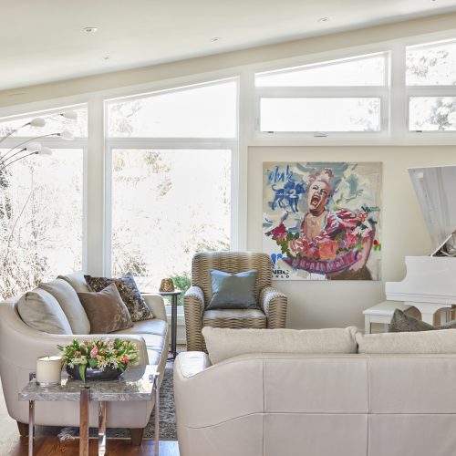 toronto mid-century home featured in toronto homes - luxury family home - living room with white piano bright art work- linda mazur design toronto designer - design build