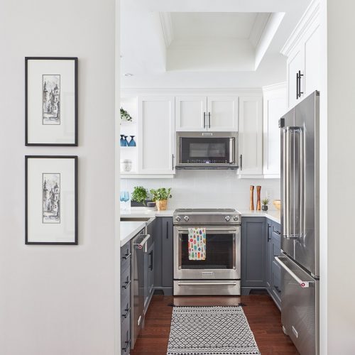 toronto condos - newmarket condo renovation - wood flooring - two colour kitchen - two color kitchen cabinetry - white and dark grey millwork - open shelving accents - microwave over slide in range - linda mazur design - newmarket design build renovate decorate