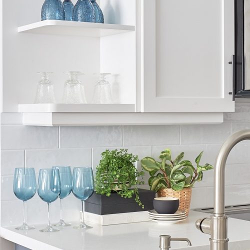 toronto condo kitchen renovation - blue accessories - open shelving display - plants add interest - decorating with plants - white counter tops and white cabinets - linda mazur design- design and decorate york region