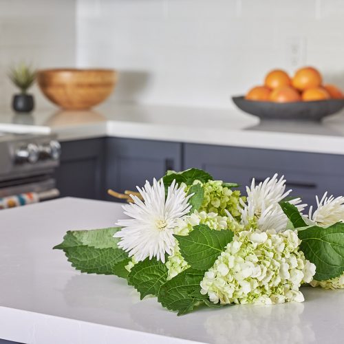 newmarket condo renovation kitchen - quartz counters - dark grey cabinetry with white subway tile backsplash - kitchen decorating - linda mazur design