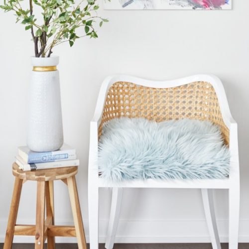 corktown condo small space living - renovations - rattan accent chair with mohair blue cushion CB2 - bright artwork - linda mazur design