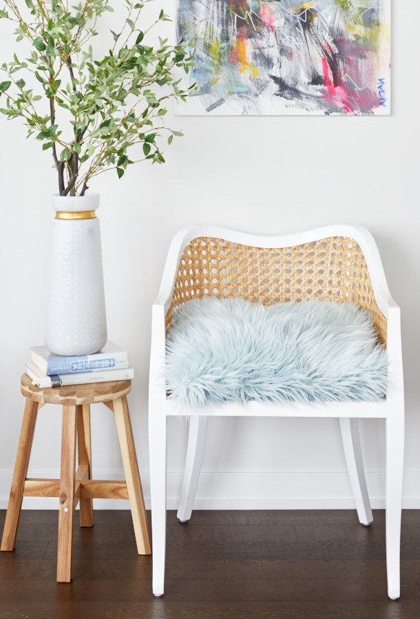 corktown condo small space living - renovations - rattan accent chair with mohair blue cushion CB2 - bright artwork - linda mazur design