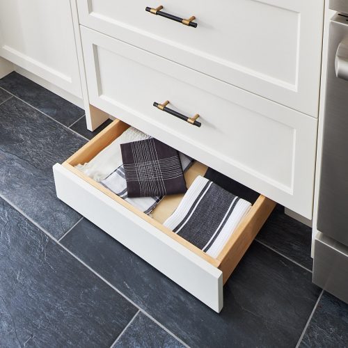 toronto luxury home kitchen renovation - toe kick drawers for additional space saving storage - black floor tile cream coloured millwork - custom kitchen - black and gold cabinet hardware CB2 - linda mazur design toronto designer