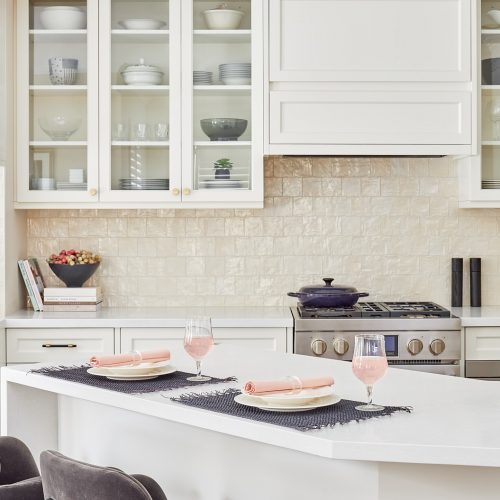 markham luxury family kitchen renovation - cream white custom millwork cabinets and range hood with glass cabinets - white quartz waterfall countertops black porcelain flooring - linda mazur design canadian designer