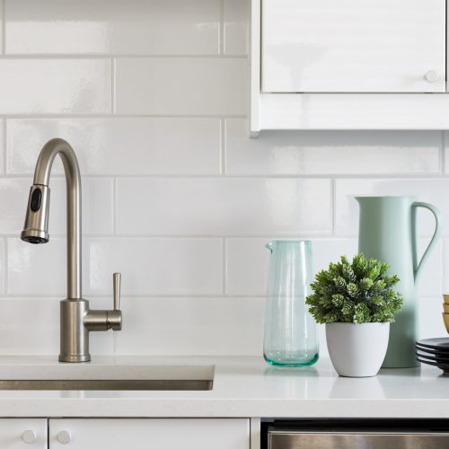 toronto condo renovation - scandi kitchen white and wood cabinetry with white quartz counter tops - wood floors and white subway tile backsplash - small space living - open concept living - toronto designer Linda mazur design