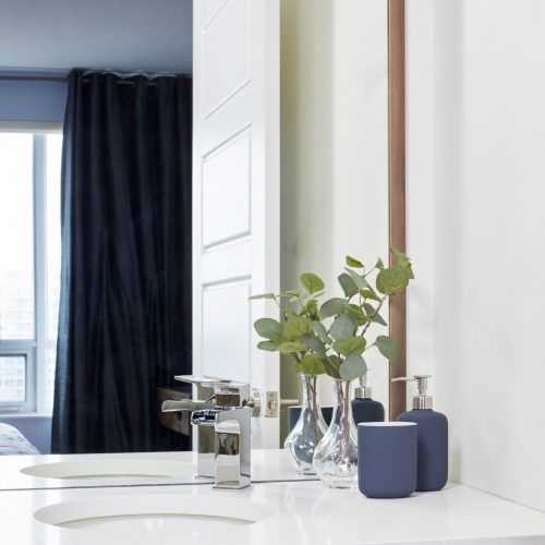 toronto condo small space living - bathroom renovation custom walnut cabinet with quartz counter - offset sink for additional counter space - small space design - linda mazur design