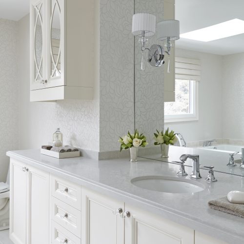 king city master ensuite bathroom - custom millwork - white and grey bathroom quartz counter top single sink large vanity with large mirror and wall sconces - linda mazur design toronto designer