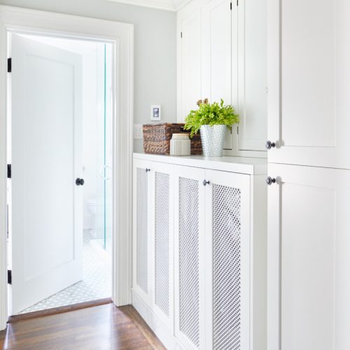 small space laundry - built in concealed laundry area - mesh door fronts - historic home - custom cabinetry - white cabinetry - linda mazur design - toronto designer - luxury family home - second floor laundry space