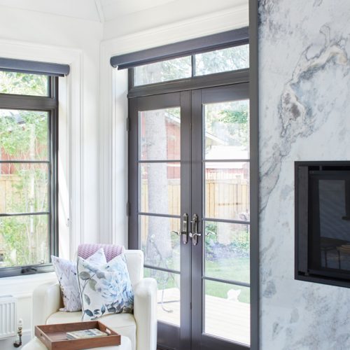 historic home - garage converted to four-seasons sunroom - custom marble modern fireplace - transitional glass french doors - vaulted ceiling - shiplap ceiling - custom millwork - blue marble fireplace surround - linda mazur design - toronto designer