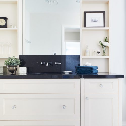 black and cream master ensuite - newmarket homes - black quartz counters with wall mount faucets - custom vanity millwork - cement tile floor - patterned floor - linda mazur design toronto designer - small space challenges