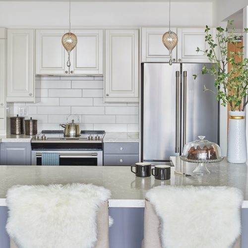 toronto condo kitchen renovation - white and blue grey custom cabinetry with wood floor quartz countertop - white tile backsplash - linda mazur design newmarket ontario