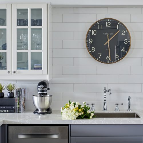 toronto condo kitchen renovation - white and grey cabinetry with glass cabinet and quartz countertop - white backsplash - linda mazur design