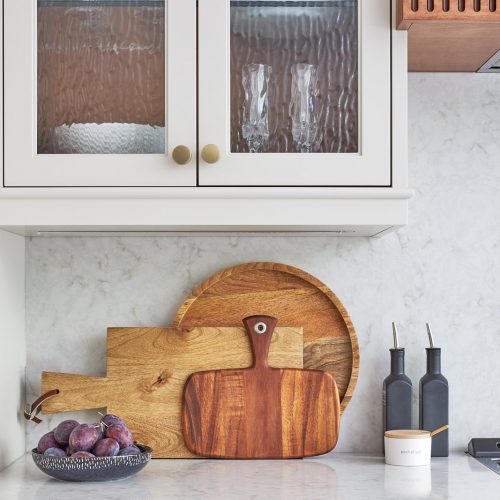 mississauga custom kitchen renovation - wood custom range hood with fluted detail - transitional - glass cabinet door fronts - quartz counter and backsplash - linda mazur design toronto designer