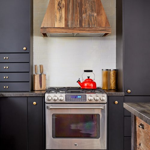 whitby kitchen renovation - small space family home - dekton countertops - cosentino - cement tile and wood floor - organic flooring pattern - black kitchen cabinets barnboard range hood - linda mazur design toronto designer