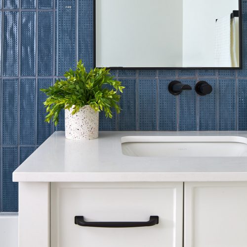 toronto condo renovations, bathroom reno, custom, blue tile, white cabinetry, wall mount faucet, black accessories, tub and shower combo, penny tile floor, toronto designer, linda mazur design